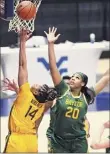  ?? Kathy Batten / Associated Press ?? West Virginia’s Kari Niblack, left, shoots over the defense of Baylor’s Hannah Gusters.