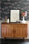  ??  ?? An original Ercol sideboard sits against a panelled and wallpapere­d wall. Kesiah added a Rockett St George print, a Holmegaard glass lamp base and a Gillian Arnold lampshade from Not On The High Street