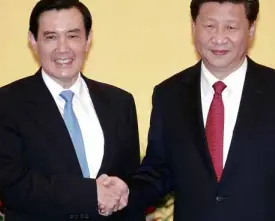  ?? AP ?? Taiwan’s President Ma Ying-jeou (left) and China’s President Xi Jinping shake hands at the Shangri-la Hotel in Singapore—the first top-level contact between the Cold War foes since 1949.