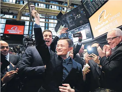  ?? Picture / AP ?? Alibaba founder Jack Ma raises a ceremonial mallet before striking a bell at the New York Stock Exchange.