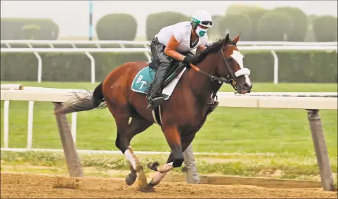  ?? Seth Wenig / Associated Press ?? Robin Smullen rides Tiz the Law during a workout at Belmont Park on Friday.