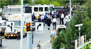  ??  ?? Authoritie­s stage at the building entrance after multiple people were shot at The Capital Gazette newspaper in Annapolis, Maryland, Thursday, June 28, 2018. (AP)