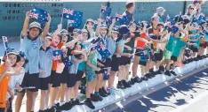  ??  ?? SUPPORT: Children cheer as the Queen’s Baton Relay runs through Cairns streets yesterday.