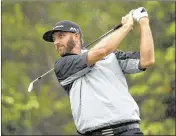  ?? RYAN KANG / AP ?? Dustin Johnson hits his tee shot on No. 4 Saturday during his second-round 66 at rainy Riviera. Johnson leads at 10-under par but still has 36 holes remaining.