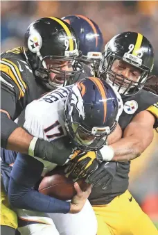  ?? CHARLES LECLAIRE, USA TODAY SPORTS ?? Steelers defenders mob Broncos quarterbac­k Brock Osweiler, who had a huge second-half drop-off after a stellar start.