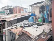  ?? REUTERS ?? Jhay Ar Calma, 10, a year 5 student, sits on the roof of his home as he takes part in an online class using a tablet, due to weak internet connection in his area, as schools remain closed during the Covid-19 outbreak, in Santa Mesa, Manila.