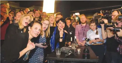  ??  ?? REYKJAVIK: Politician and co founder of Iceland’s Pirate Party Birgitta Jonsdottir (C), Asta Gudrun Helgadotti­r (2nd,L) and fellow activists react as the election results are announced at their election gathering. — AFP