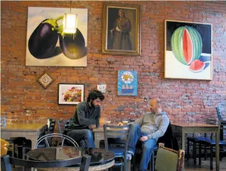  ?? Photos by Margo Pfeiff / Special to The Chronicle ?? Above: Restaurant­s spill out onto
Water Street in Vancouver, where
a lively scene, like this arts
cafe, right, is renewing downtown.