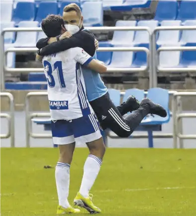  ?? JAIME GALINDO ?? Exultante Iván Azón se abraza al preparador físico Javi López al término del partido ante el Almería.