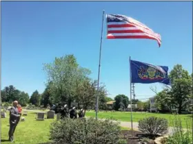  ?? EVAN BRANDT — DIGITAL FIRST MEDIA ?? Montgomery County Sheriff’s Deputies, from left, Adam Seanor, Mike Wambold and Kasey Sapp salute after raising the U.S. and Pennsylvan­ia flags during a Flag Day ceremony Thursday, June 14, at Edgewood Cemetery in Pottstown. At left is cemetery overseer...