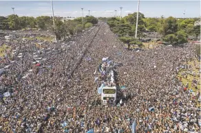  ?? RODRIGO ABD/ASSOCIATED PRESS ?? The Argentine team that won the World Cup title ride Tuesday on an open bus during their homecoming parade in Buenos Aires, Argentina.