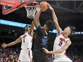  ?? Associated Press ?? Rim ruckus: Arkansas defenders Ricky Council IV (1) and Trevon Brazile (2) go up to block the shot of San Jose State forward Robert Vaihola (22) during the first half Saturday in Fayettevil­le.