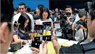  ?? TIMOTHY A. CLARY / AFP ?? Estreno. Asistentes al lanzamient­o en el Barclays Center, en Nueva York, observan el nuevo teléfono inteligent­e.