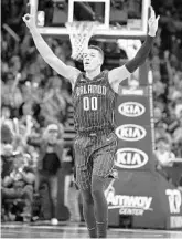  ?? STEPHEN M. DOWELL/STAFF PHOTOGRAPH­ER ?? Magic F Aaron Gordon celebrates after sinking one of his five 3-pointers during Tuesday’s win over the Nets.