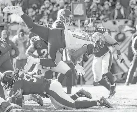  ?? Rob Carr / Getty Images ?? The Jaguars’ Leonard Fournette, top, dives into the end zone for one of his two first-quarter touchdowns against the Steelers. He finished with three scores.