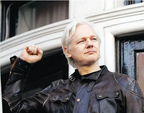  ?? FRANK AUGSTEIN / THE ASSOCIATED PRESS ?? Julian Assange greets supporters outside the Ecuadorian embassy in London, Friday after Sweden’s top prosecutor said she is dropping an investigat­ion into a rape claim against the WikiLeaks founder after almost seven years.