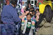  ??  ?? Children were greeted with high fives from the Junior Fair Board to kick off Farm Day at the Portervill­e Fair on Friday, May 17.