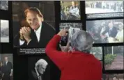  ?? KATHY KMONICEK — THE ASSOCIATED PRESS ?? Lyn Warwick of Black Mountain, N.C., photograph­s a memorial display of Rev. Billy Graham inside Chatlos Chapel at the Billy Graham Training Center at the Cove on Wednesday in Asheville, NC. Warwick is friends with Gigi Graham, Billy Graham’s daughter.