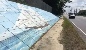  ?? AP PHOTO/KEVIN MCGILL, ?? Traffic passes a mural of the slave ship Clotilda along Africatown Boulevard in Mobile, Ala., in June.