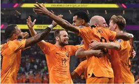  ?? Photograph: Noushad Thekkayil/EPA ?? Cody Gakpo (centre) receives a loving embrace after scoring the Netherland­s’ winner over Senegal.