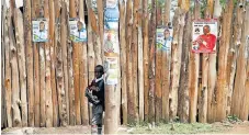  ??  ?? Standing: Campaign posters advertise candidates to represent the Barut ward in Nakuru, Kenya, in next week’s poll