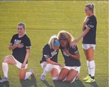  ?? Rick Bowmer / Associated Press ?? The Chicago Red Stars’ Julie Ertz hugs Casey Short during the national anthem before their game in Herriman, Utah.