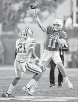  ?? Eric Gay / Associated Press ?? Texas quarterbac­k Sam Ehlinger, right, shook off an early mistake to pilot the Longhorns to 40-34 double-overtime win to improve to 2-0 in the Big 12.