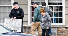  ?? HYOSUB SHIN / HYOSUB.SHIN@AJC.COM ?? Family members are relegated to celebratin­g a loved one’s birthday through a window Tuesday at The Retreat at Canton, where three residents and an employee tested positive for COVID-19. Some 50 residents there are living in self-isolation.