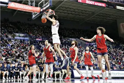  ?? AP Photo/Young Kwak ?? ■ Gonzaga center Chet Holmgren (34) dunks during the second half of an NCAA game against Saint Mary’s on Saturday in Spokane, Wash. Gonzaga won, 74-58.