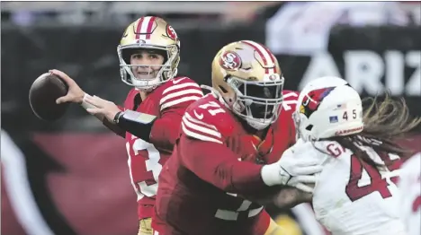  ?? AP PHOTO/MATT YORK ?? San Francisco 49ers quarterbac­k Brock Purdy (13) passes as offensive tackle Trent Williams blocks Arizona Cardinals linebacker Dennis Gardeck (45) during the second half of an NFL football game on Sunday in Glendale, Ariz.