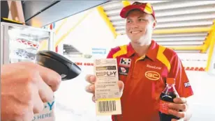  ??  ?? Suns fan Thomas Beverley tries out the new pre-paid ticketing system to buy food and drinks at Metricon Stadium. Photo: JERAD WILLIAMS