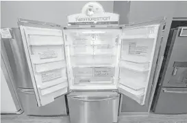  ?? Rick Bowmer / Associated Press file ?? The Kenmore Elite Smart French Door Refrigerat­or appears on display at a Sears store. The owner of Sears is selling its Kenmore-branded appliances on Amazon in some markets.