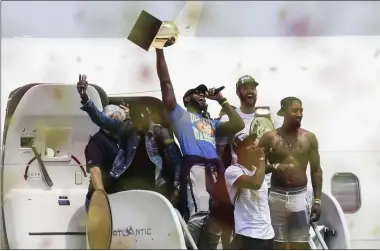  ?? JOHN MINCHILLO — THE ASSOCIATED PRESS ?? Lebron James, center, holds up the NBA Championsh­ip trophy alongside teammates Kyrie Irving, left, Kevin Love, rear right, J.R. Smith, right, and Tristan Thompson, front, at the airport in Cleveland, June 20, 2016.