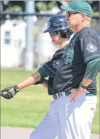  ?? JASON SIMMONDS/JOURNAL PIONEER ?? Team P.E.I.’s Landon Clow and assistant coach Carl Picketts chat at first base during a break in the action of Thursday afternoon’s action at the 2017 Ray Carter Cup. Clow had just singled to score P.E.I.’s third run in the top of the fifth inning. The...