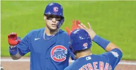  ?? AP ?? The Cubs’ Javy Baez is greeted by Willson Contreras after his three-run home run.