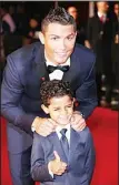  ??  ?? Cristiano Ronaldo and his son Cristiano Ronaldo Junior (foreground) pose for photograph­ers upon arrival at the world premiere of the film ‘Ronaldo’ in London on
Nov 9. (AP)