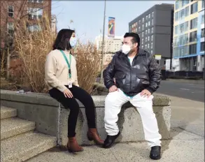  ?? Tyler Sizemore / Hearst Connecticu­t Media ?? Community Health Worker Adriana Rosario and client Jose Lopez chat outside the Government Center in Stamford on Thursday. The City of Stamford and Family Centers partnered to put "boots on the ground" by creating a team of Community Health Workers to help underserve­d population­s recovering from COVID-19. Rosario noticed Lopez was in bad shape when dropping off supplies for him and insisted that he receive medical attention for his dangerousl­y low blood-oxygen level. Without the interventi­on of Community Health Workers, Lopez’ condition may have gone undetected.