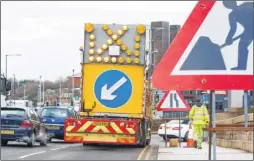  ??  ?? KCC Highways workers put out cones and road signs around Maidstone’s gyratory system