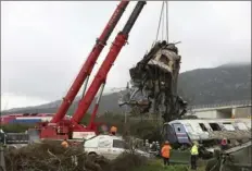  ?? ?? Rescuers using cranes and heavy machinery on Thursday searched the wreckage of trains involved in the collision.