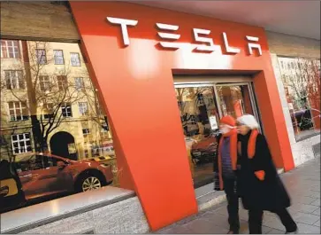  ?? Sean Gallup Getty Images ?? TESLA’S Elon Musk has acknowledg­ed that a lack of service centers is hampering his electric-car company’s growth in Germany, where it is facing many customer complaints. Above, a Tesla dealership in Munich.