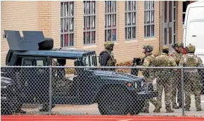  ?? AP ?? Law enforcemen­t teams stage near Congregati­on Beth Israel during a hostage drama at the Texas synagogue.