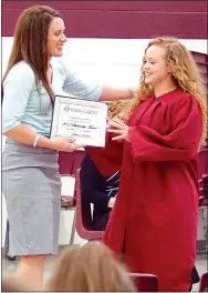  ?? Photo by Randy Moll ?? Gentry senior Makensi Sweeten (right) receives a scholarshi­p award from Savannah Dickinson of Farm Credit Services of Western Arkansas during the academic awards event at Gentry High School on May 8.