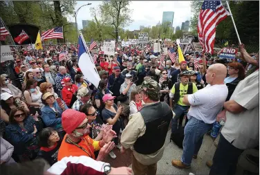  ?? (AP/The Boston Herald/Nancy Lane) ?? Demonstrat­ors calling for an end to the coronaviru­s lockdown gather Monday outside the Massachuse­tts Statehouse in Boston.