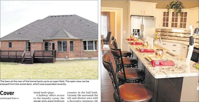  ??  ?? The lawn at the rear of the home backs up to an open field. The open view can be enjoyed from the wood deck, which was expanded recently.
ABOVE: The kitchen’s counters are topped with bevel-edged granite in a natural contrast to white cabinets with...