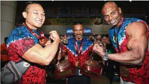  ?? — NORAFIFI EHSAN / The Star ?? All smiles: (from left) Muhammad Roszaimi, Buda Anchah and Syarul Azman Mike Mahen posing for a photograph at the Kuala Lumpur Internatio­nal Airport on Friday.