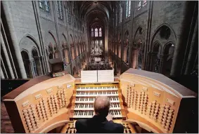  ?? CHRISTOPHE ENA/AP FILE PHOTO ?? Philippe Lefebvre plays the organ May 2, 2013, at Notre Dame Cathedral in Paris. The organ that once thundered through the fire-ravaged cathedral is being taken apart. The mammoth task of dismantlin­g, cleaning and reassembli­ng France’s largest musical instrument started Monday and is expected to last nearly four years.