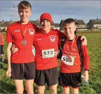  ??  ?? Karl Carton with sons James and Lucas at the Christmas 5K in the Lourdes Stadium.