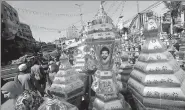  ?? AMR ABDALLAH DALSH / REUTERS ?? People walk near
traditiona­l lanterns known as fanoos, with the image of Liverpool’s Egyptian soccer player Mohamed Salah, before Ramadan in Cairo on Wednesday.