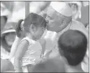  ?? GREGORIO BORGIA/ THE ASSOCIATED PRESS ?? Pope Francis kisses a girl Saturday as he celebrates the beatificat­ion of 124 South Korean martyrs in Seoul, South Korea.