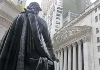  ?? AP FILE PHOTO/ RICHARD DREW ?? A statue of President George Washington on the steps of Federal Hall faces the facade of the New York Stock Exchange.